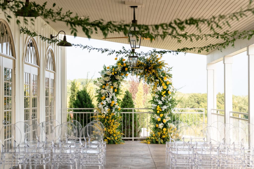 Image captured by Event + Filmmaker.  Ceremony space with a floral arch at Westwind Hills located outside of St Louis, MO 63052